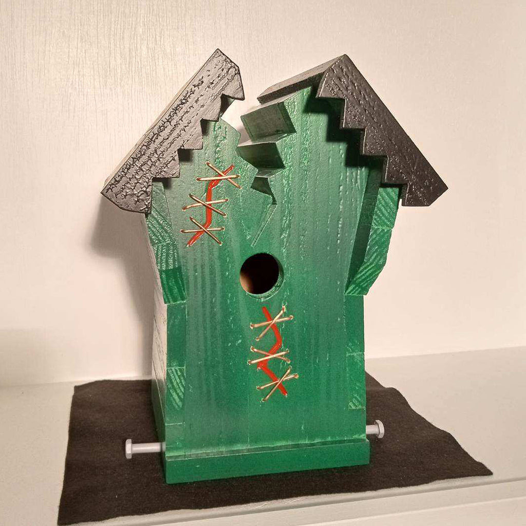 Green birdhouse with red lighting accents
